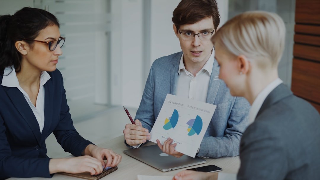 About Angry businessman disappointed with company financial reports and scolding employees sitting at the table in meeting room indoors